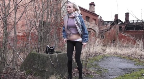 Blonde girl Masha pulls down black leggings to piss on mossy terrain 95939987