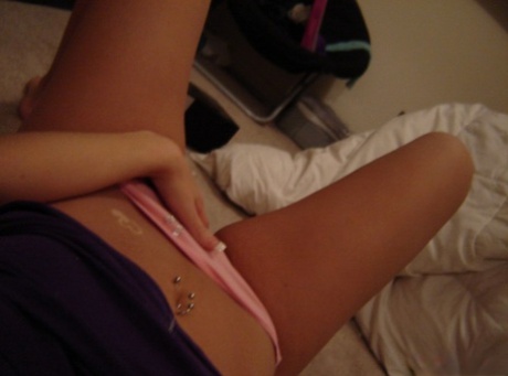 Blonde teen shows her belly button piercing in pink underwear 26361628