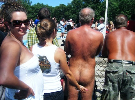 Men and women take in an outdoor strip show at a clothing optional club 33166049