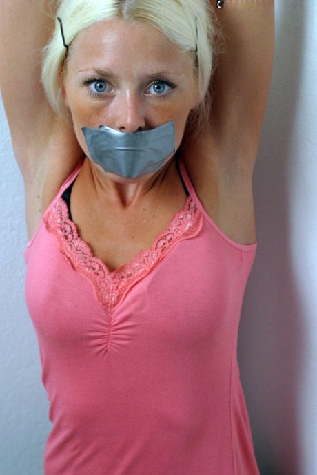 Clothed blonde is shut up with duct over mouth and wrists tied together 24690026