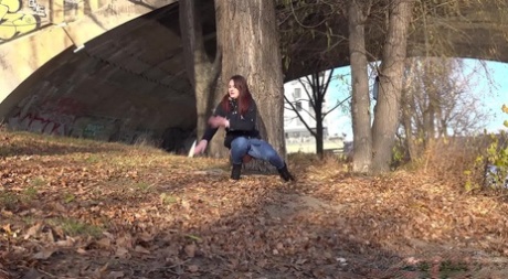 Solo girl Amanda Hill pulls down her jeans for a pee behind a tree in public