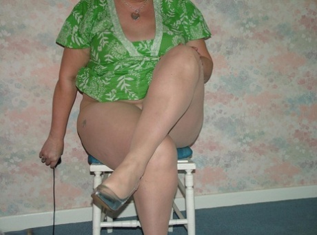 Older redhead BBW Valgasmic Exposed strips to pantyhose atop a wooden chair 48127214
