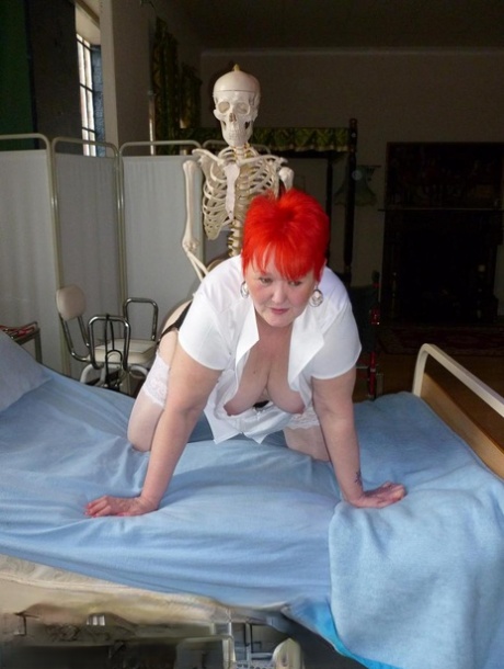 Older redhead nurse Valgasmic Exposed gets banged by a dildo wielding skeleton 54969004