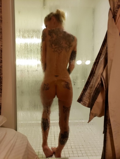 Tattooed girl with fake tits has sex in a bathroom with a tattooed man 55106162