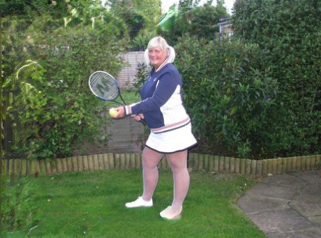 Mature BBW Chrissy Uk exposes her tits and ass while wielding a tennis racket 67084638