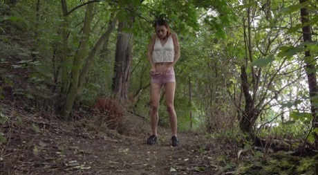 Skinny girl Adele Unicorn takes a badly needed piss on a path in the woods