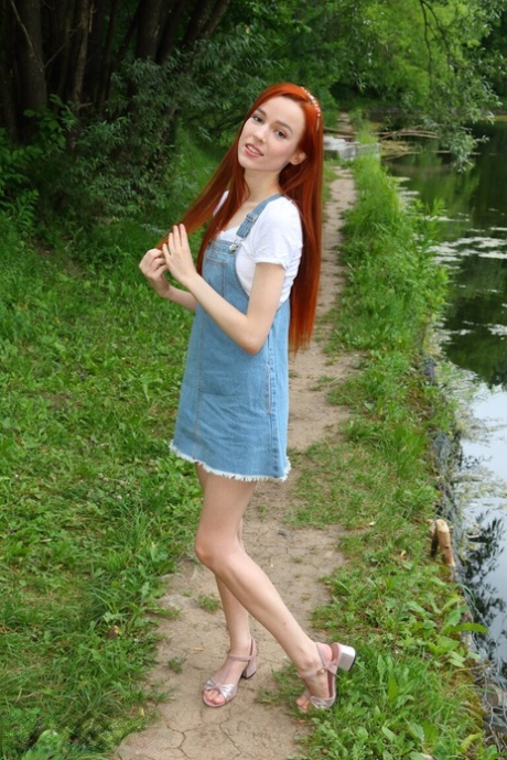 Young redhead Sherice exposes her slender body near a calm body of water 37786544