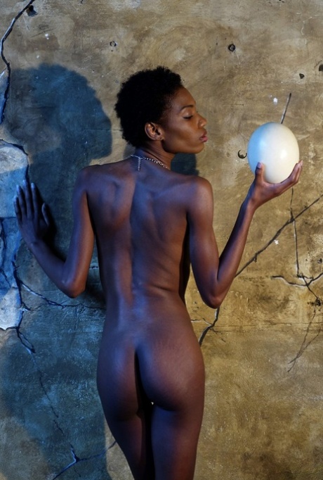 Dark skinned girl Jess holds a large egg while modeling butt naked 44436381