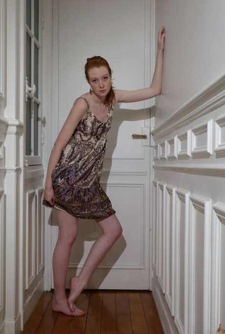 Pale redhead Nathalie Lawson exposes her upskirt underwear in a hallway