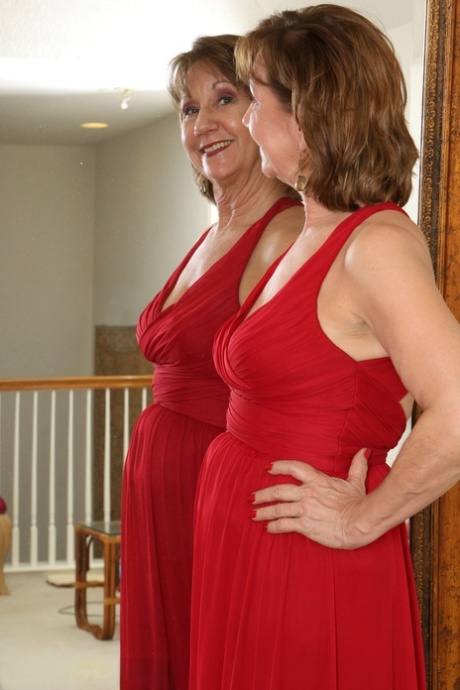 30 plus redhead Lynn doffs a long red dress before pussy play afore a mirror 54614535