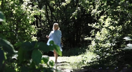 Petite blonde Masha squats for an urgent piss by riverside bushes