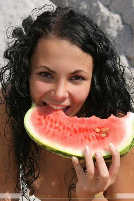 Young amateur Amber Pearl consumes a watermelon while naked on boulders 71012069