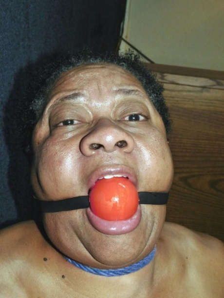 Overweight black woman Trixie struggles against a ball gag while hogtied 67141761