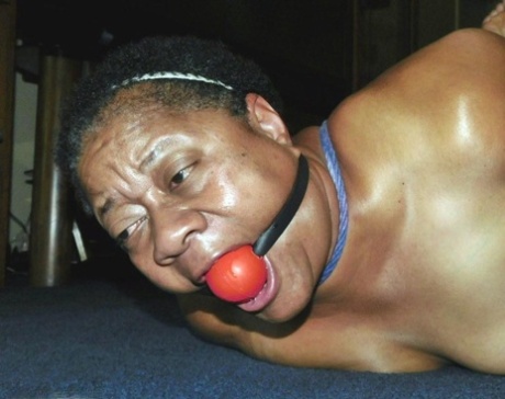 Overweight black woman Trixie struggles against a ball gag while hogtied 67141761