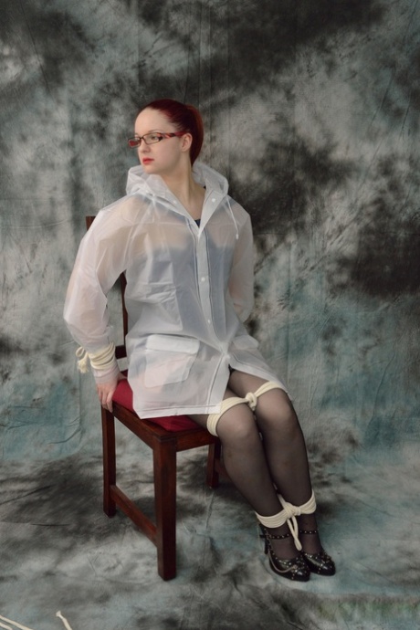 Redheaded chick in a raincoat and glasses gets tied up and gagged 42004406