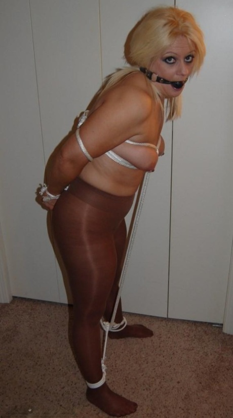 Chubby blonde Adrienna sports a ball gag while tied up in shiny pantyhose 42023187