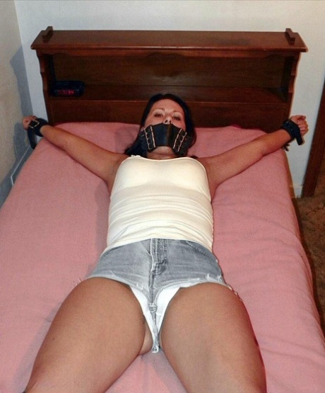 Solo girl is cleave gagged and hogtied on a bed in denim cutoffs 85403301