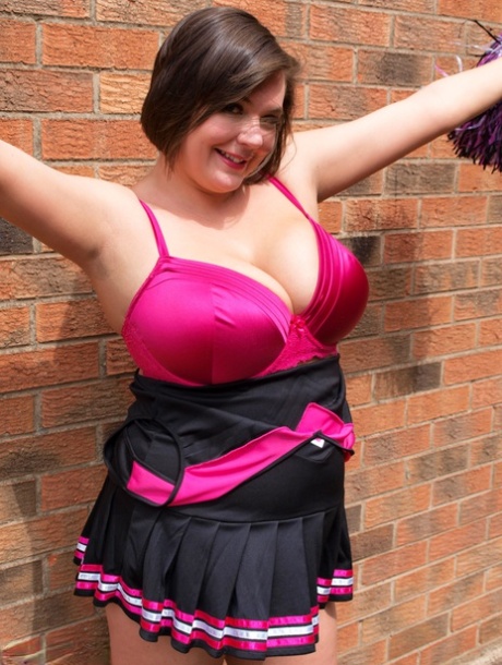 Chubby cheerleader Roxy uncovers her large tits against a brick wall 64762240