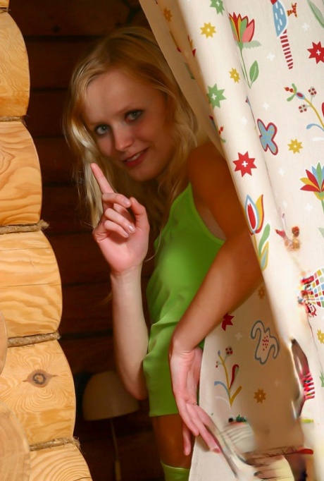 Cute 18 year old blonde Yana F strips to her socks in a saucy manner