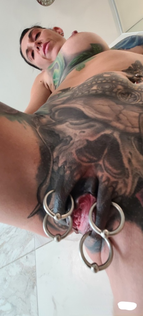 Tatted older woman Marie Bossette highlights her pierced pussy while showering