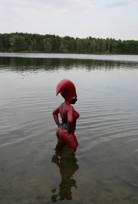 Fetish model Avengelique wades into a body of water in a rubber costume 32835388