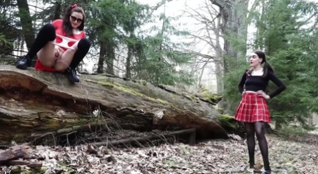 Sexy brunette takes a piss on a fallen tree while her girlfriend watches 84917303