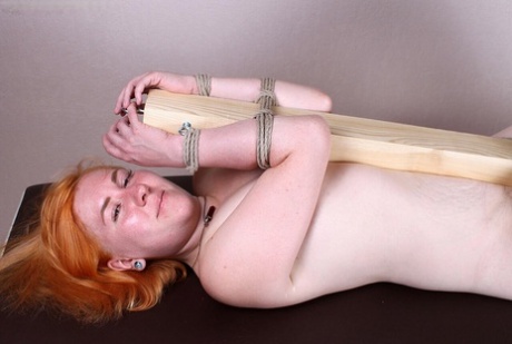 Flaming redhead Florence is tied to a wooden post while bare naked 87792804