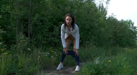Caucasian chick Kristina pulls her pants down to take a piss on a rural path 64971780