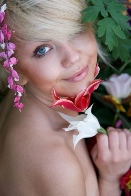 Cute young blonde Iveta poses in the nude while in a garden 69702748