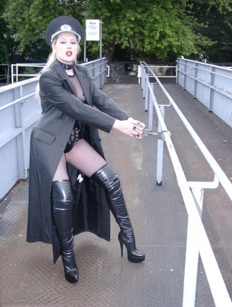 Solo model Avengelique poses in fetish wear alongside a waterway 74954230