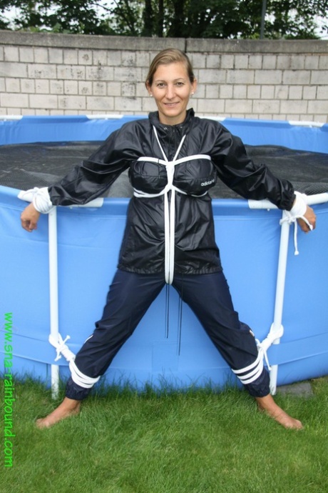 Amateur woman Sandra is gagged and tied to a pool in a raincoat 43671493