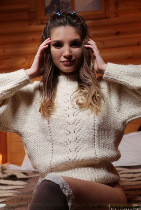 Gorgeous teen Emilia Hops doffs a big sweater to model nude in OTK hosiery 86993474