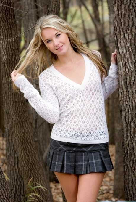 Beautiful blonde schoolgirl Jewel gets naked amid a stand of trees 31975613