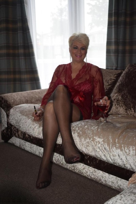 Older blonde Dimonty models sexy lingerie and stockings over a drink 34312391