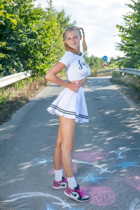 Blonde teen Nana strips to her socks and runners on a paved road 19783365