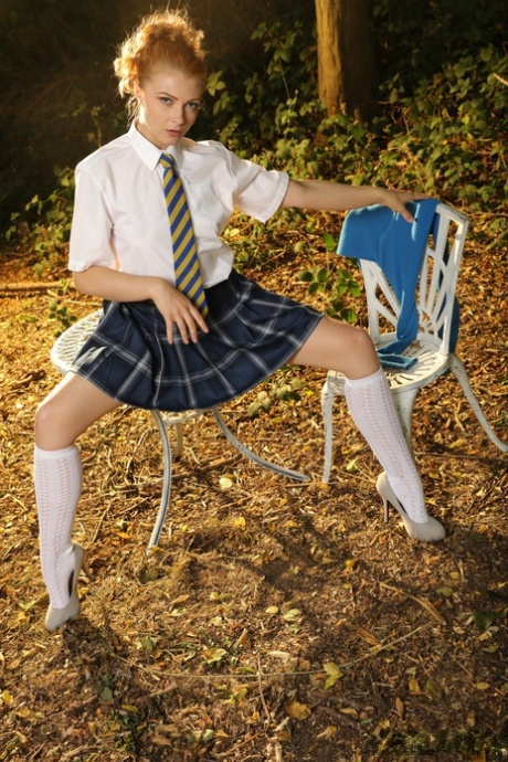Schoolgirl Scarlett Foxett gets naked in the woods while wearing white socks 31093831