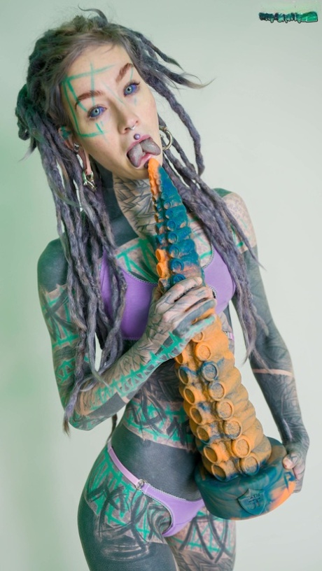 Heavily tattooed girl Anuskatzz holds a couple of taintacle toys in the nude 61932882