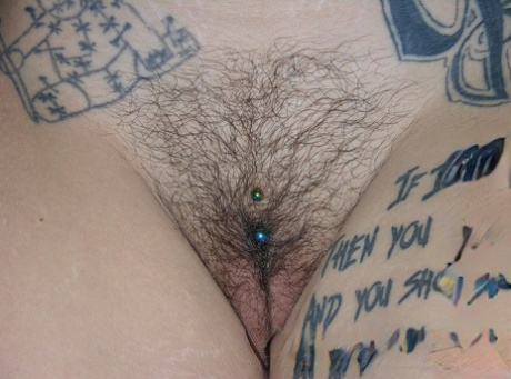 Tattooed redhead Jae Model displays her pierced bush after going nude 41264423