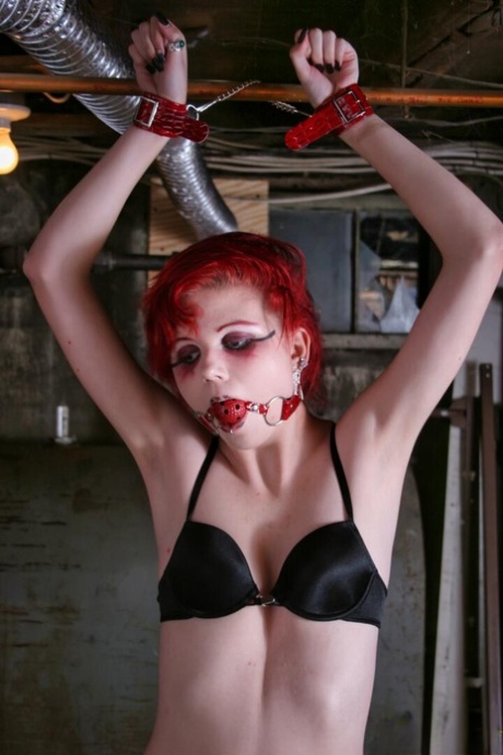 Redheaded teen Teen Satine is left cuffed and gagged in an unfinished basement 97111441