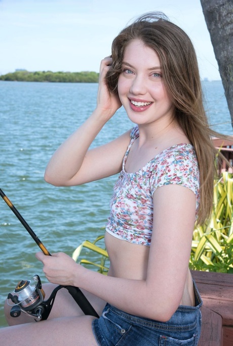 Sweet teen Elena Koshka uncovers her tiny breasts while fishing from shore 17407832