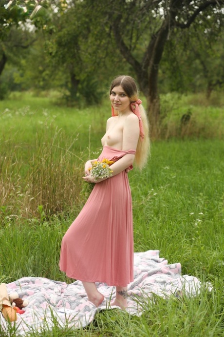 Young beauty Suna gets butt naked on a blanket while in a wooded area 41915009