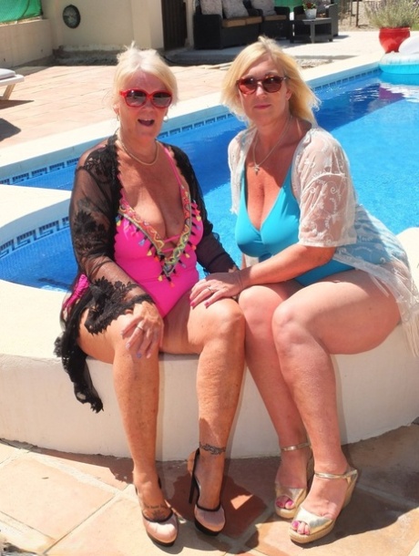 Mature blonde fatty Melody and her lesbian lover have foot play near a pool 67311604