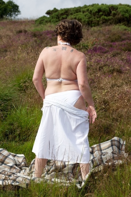Mature lady Dirty Doctor goes topless on a blanket in a field 30144200