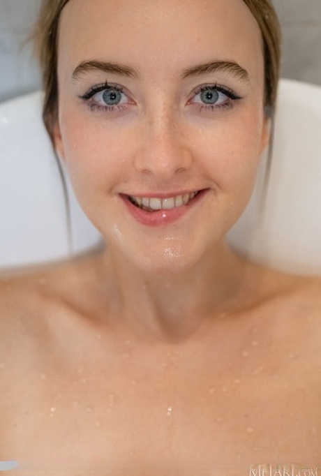 Blonde teen Ann Joy splashes water on her natural tits in a bathtub 57596544