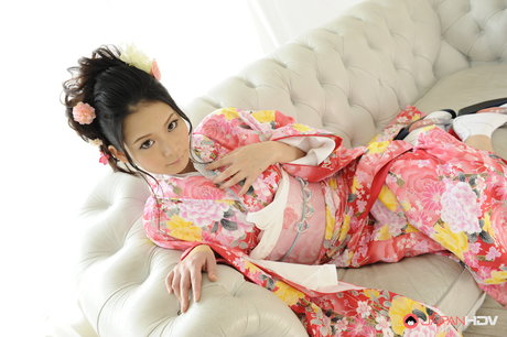 Japanese beauty Ako Nishino works free of traditional clothing on a couch