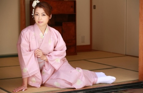 Japanese beauty Maki Hojo plays with her bush while wearing a robe and socks 30723277