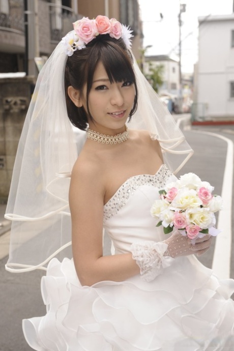 Beautiful Japanese bride Ruri Narumiya poses on the street during her big day 60146335