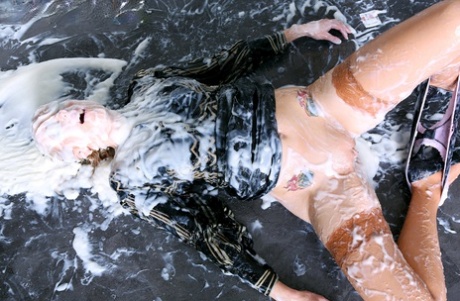 Fully clothed blonde hikes up a black skirt while getting plastered in slime 79210614