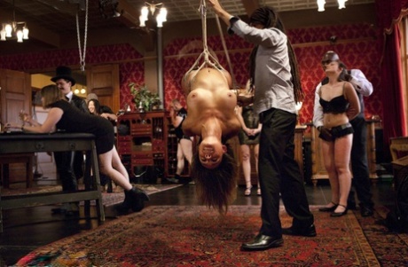 Blond sex slaves are suspended during a dinner party before being used for sex 20492921