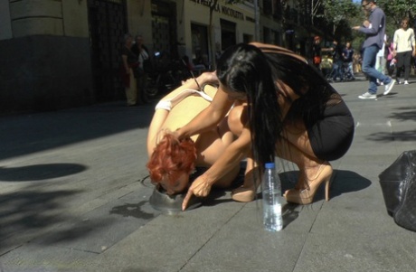 Redheaded girl is humiliated in public before being fucked afore a crowd